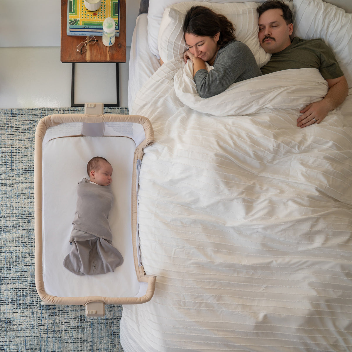 Halo 2-in-1 Bedside Bassinet Sleeper attached to a bed