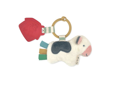 Soft plush cow Carmen the Itzy Pal™ with crinkle ears, silicone teething ring, and colorful ribbon tags. Stimulates tactile exploration, soothes sore gums, and engages babies with sensory sounds for developmental play.