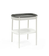 Stokke Sleepi Changing Table – sleek wooden diaper changing station with open storage shelves and soft curved edges for modern nurseries.