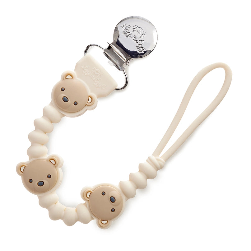 Soft silicone pacifier strap with a smiling bear charm, securely attaches to baby's clothing to prevent pacifier loss. Hypoallergenic and chew-safe design for teething infants.